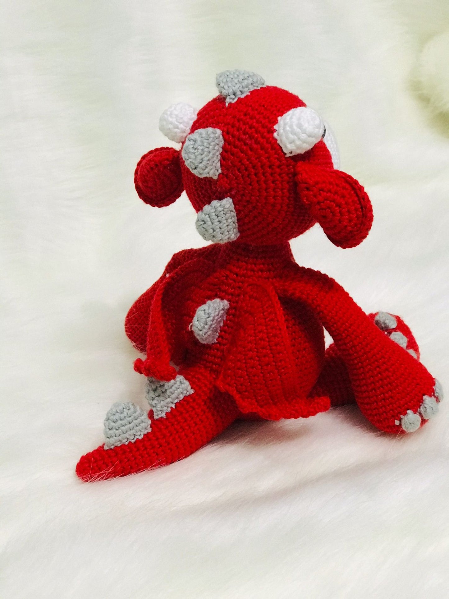 An adorable handmade Corgi Dragon Amigurumi in red and white with little wings