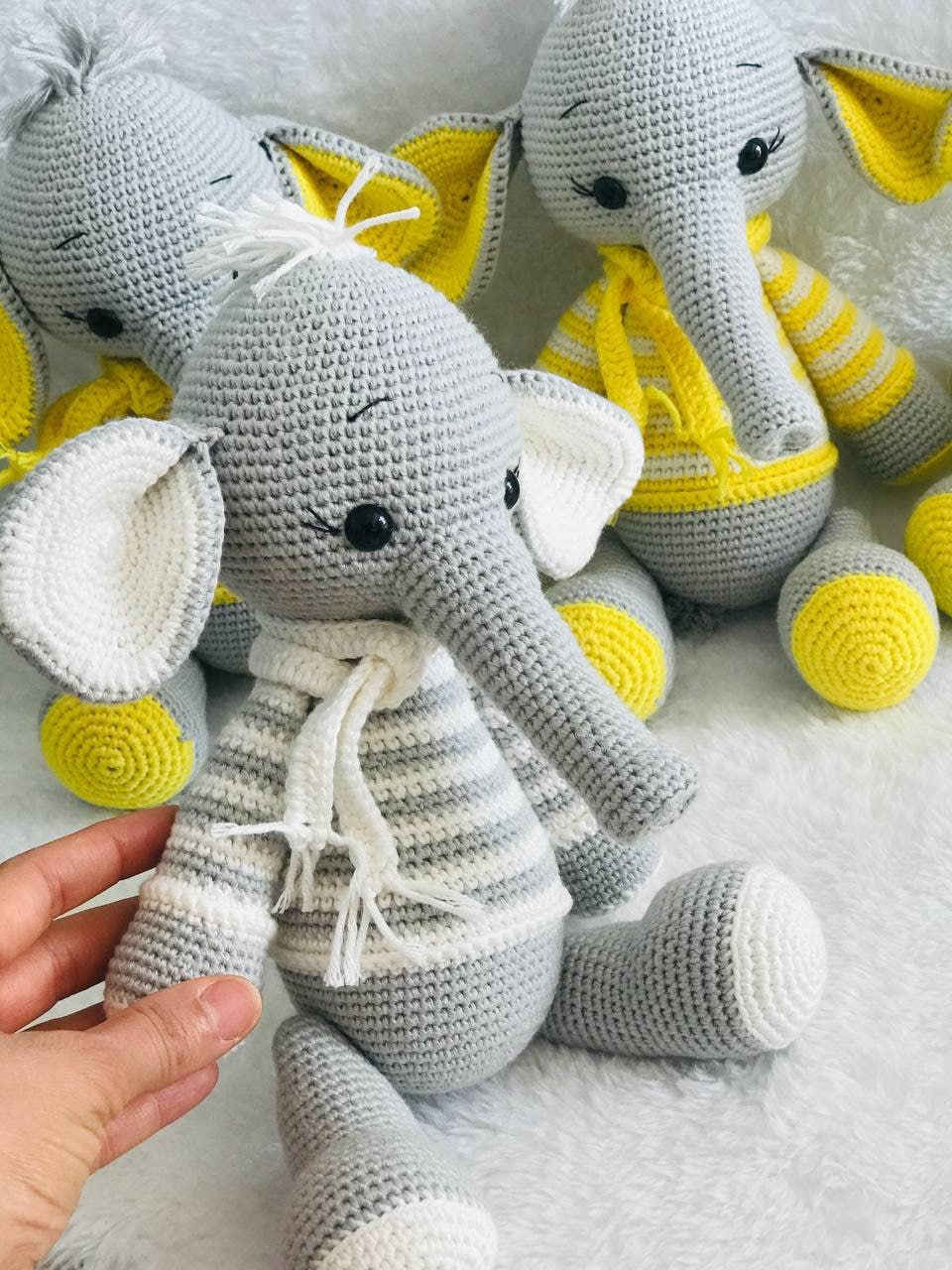 Hand-crocheted baby elephant toy with a large head, soft body, and long trunk