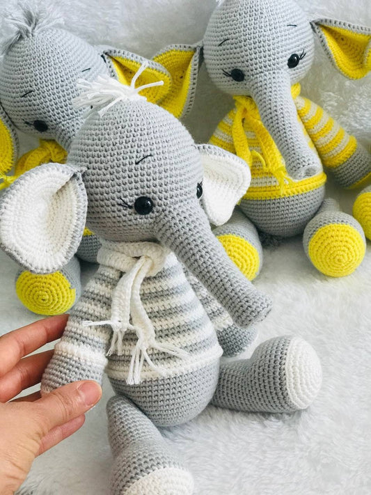 Hand-crocheted baby elephant toy with a large head, soft body, and long trunk