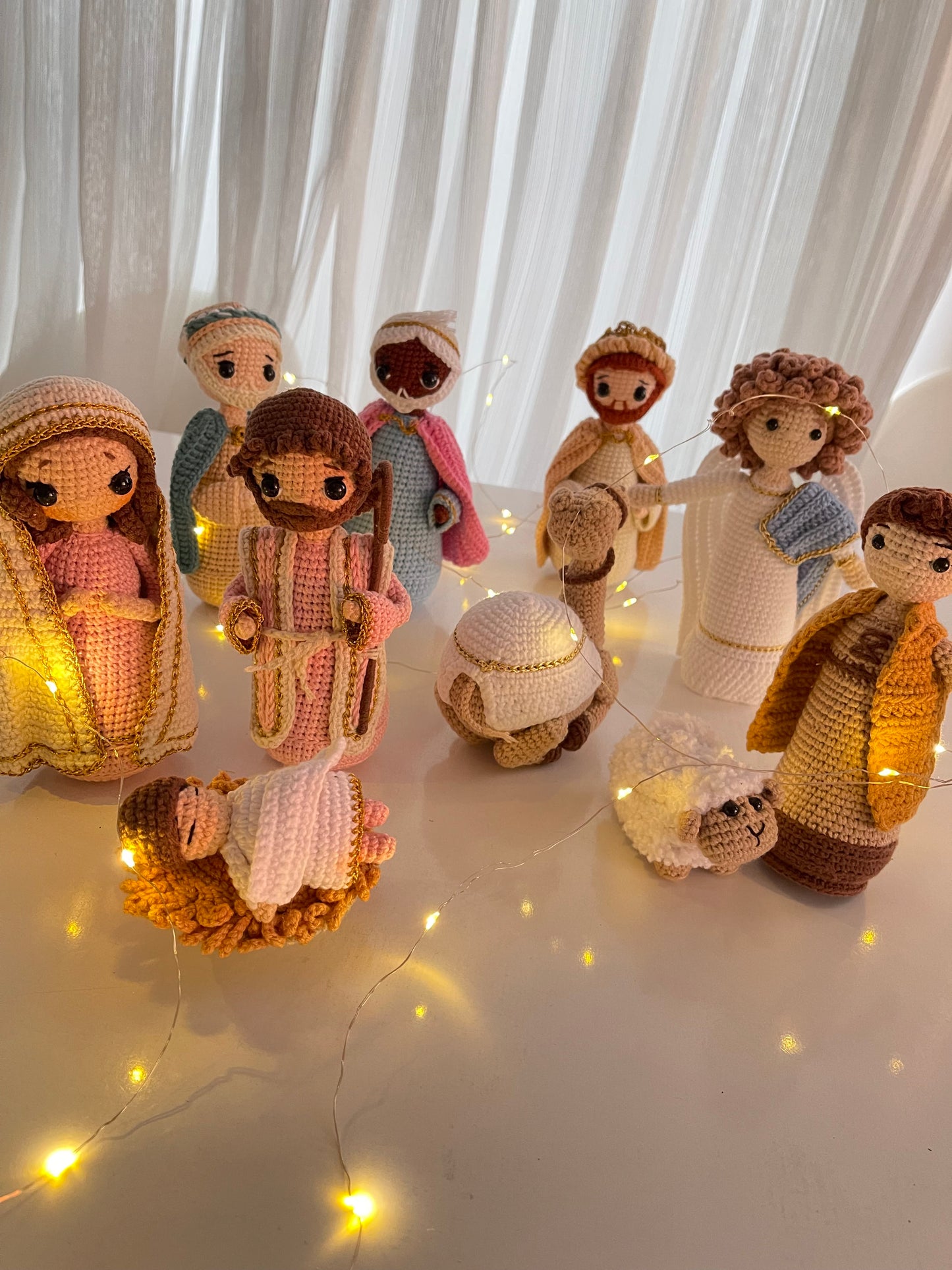 Artisan Amigurumi Nativity set, showcasing the Holy Family, the Magi, a shepherd, and animals, all crafted from yarn