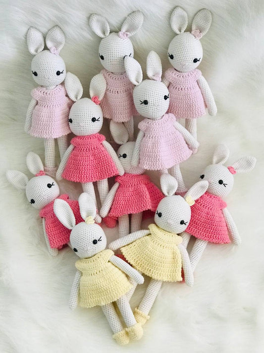 A collection of sweet pastel Amigurumi bunnies with perky ears and fluffy tails.
