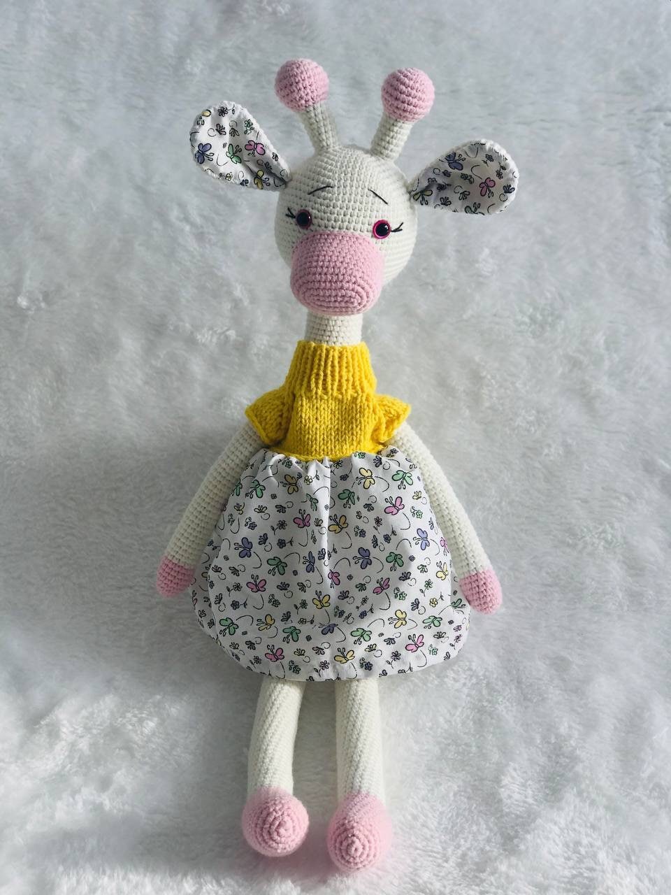 Close-up of a handmade crochet giraffe toy showing its soft yarn and intricate stitching