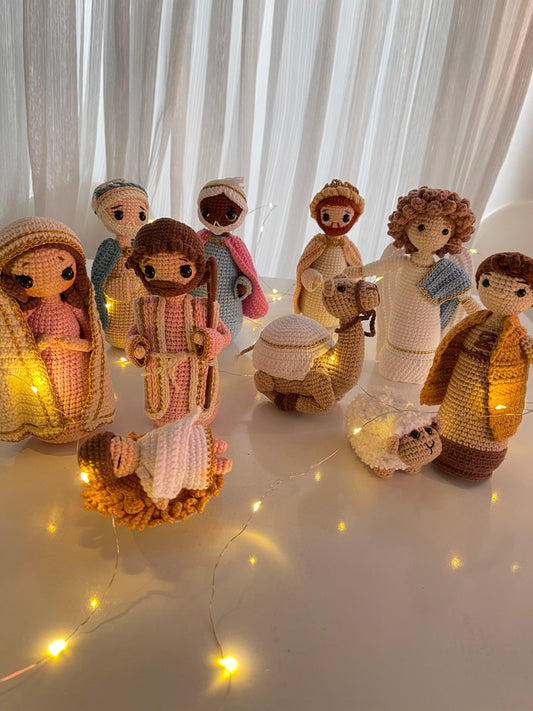 Hand-crocheted Christmas Nativity set with Mary, Joseph, Baby Jesus in a manger, three wise men, a shepherd, sheep, and a camel