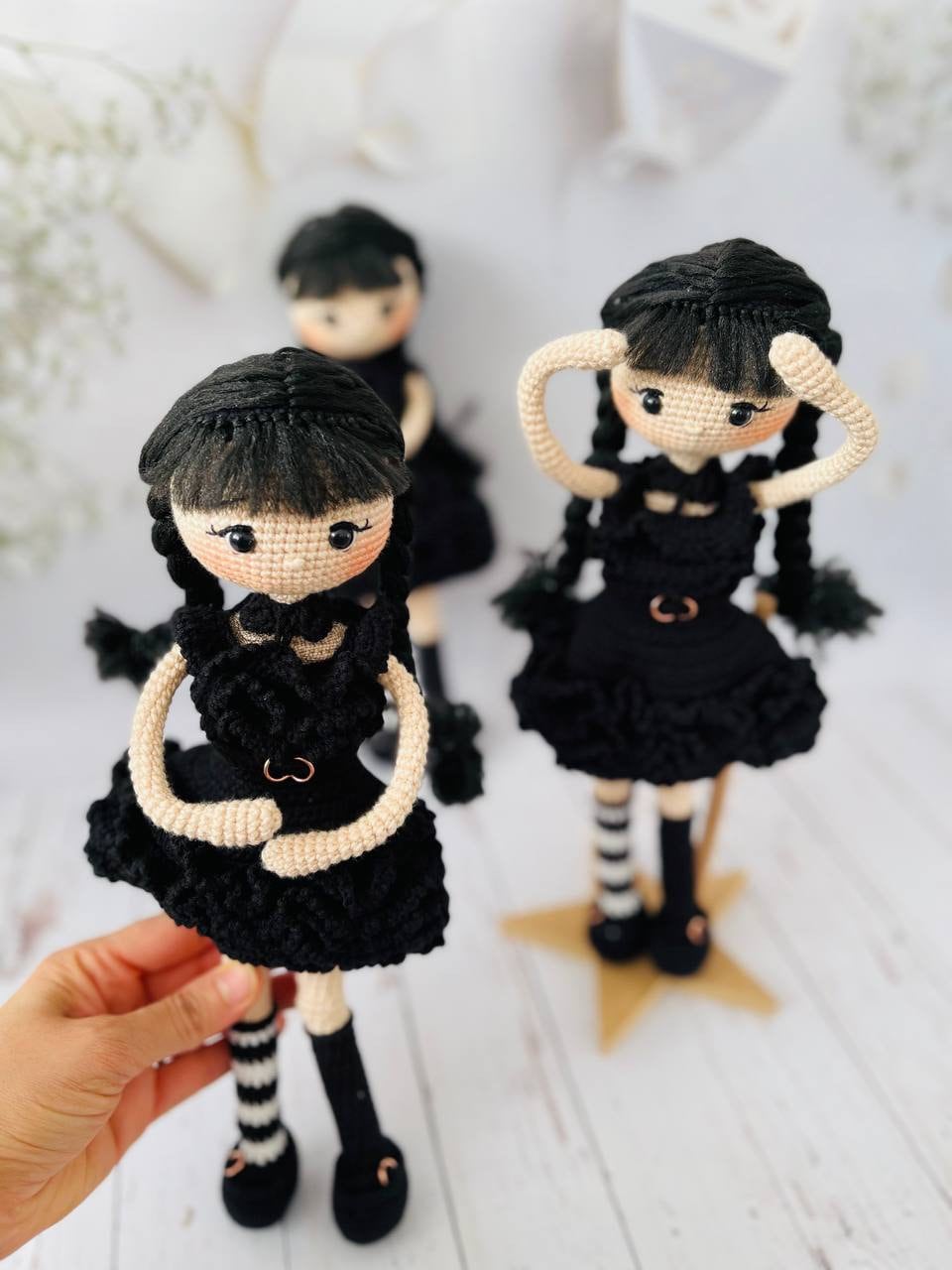Hand-crocheted Wednesday Addams inspired doll wearing her black raven party dress
