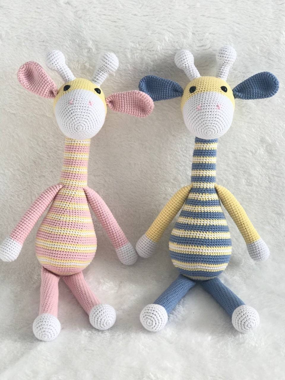 This is an instantly eye-catching a crocheted colorful giraffe with a white horn! The giraffe appears to have been made from soft, colorful yarn that's been cleverly shaped and manipulated by skilled hands into its gentle curves.