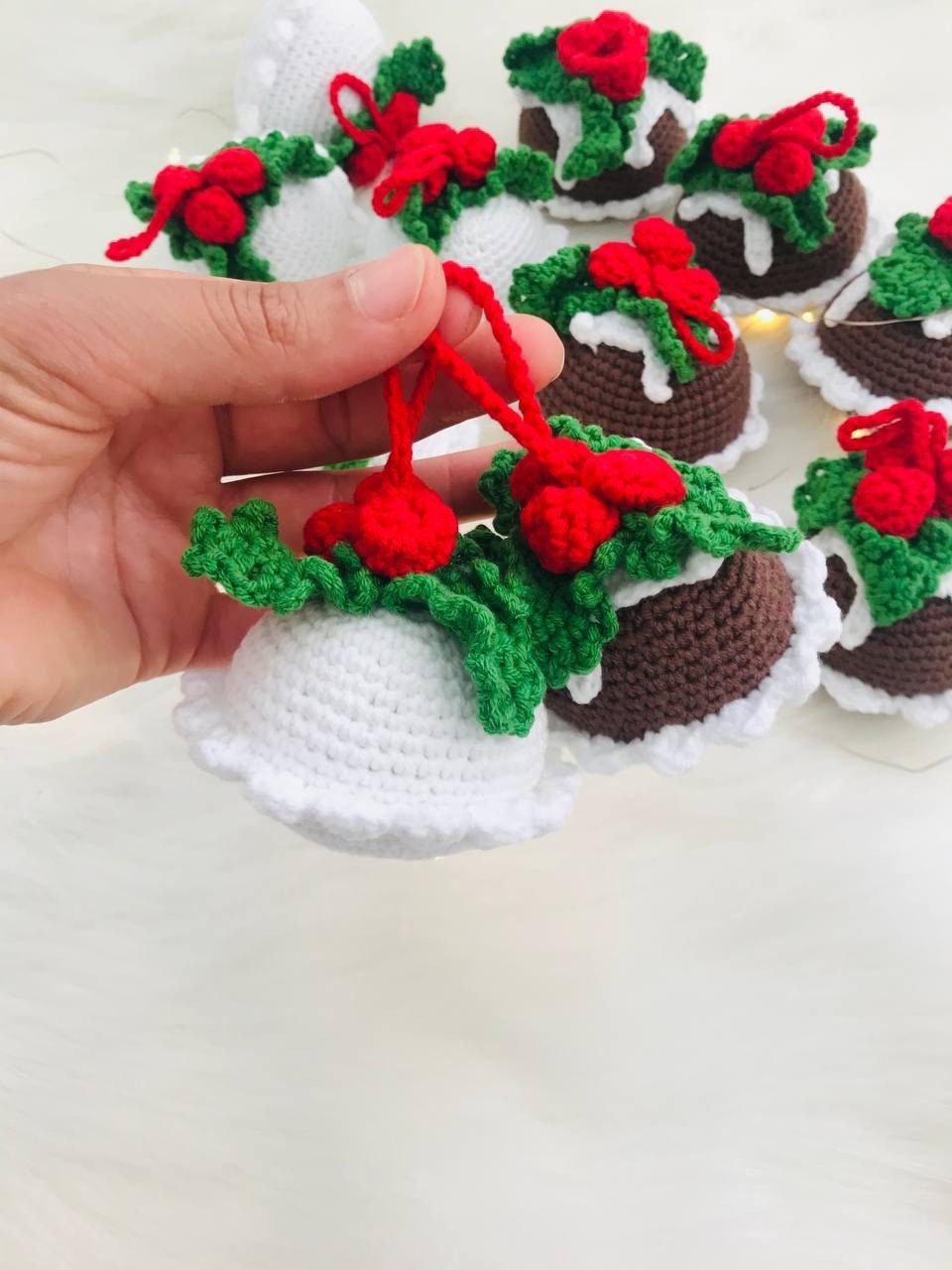 Crochet Christmas pudding ornament with chocolate and white colors, perfect for decorating your tree or adding a touch of holiday charm to your home decor. Handmade with love, this cute piece is sure to delight anyone who loves the festive season