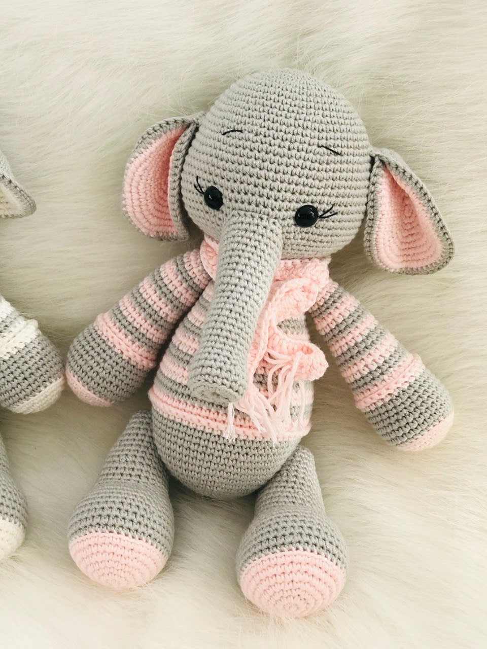 This crocheted elephant's craftsmanship and attention to detail are evident from the striped tusks down to the swirly patterned stripes. What's more impressive is how symmetrical this creature is; every stripe perfectly parallels another.