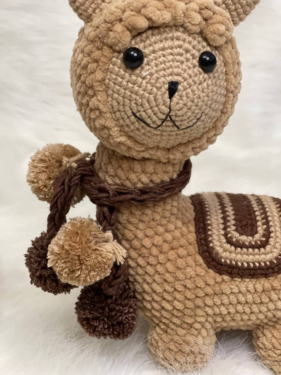 This charming crocheted alpaca comes in either a white or brown variant, both featuring soft colors that capture the gentle nature of the llama species. The adorable face and top knot pair wonderfully well with the posable legs and tail.