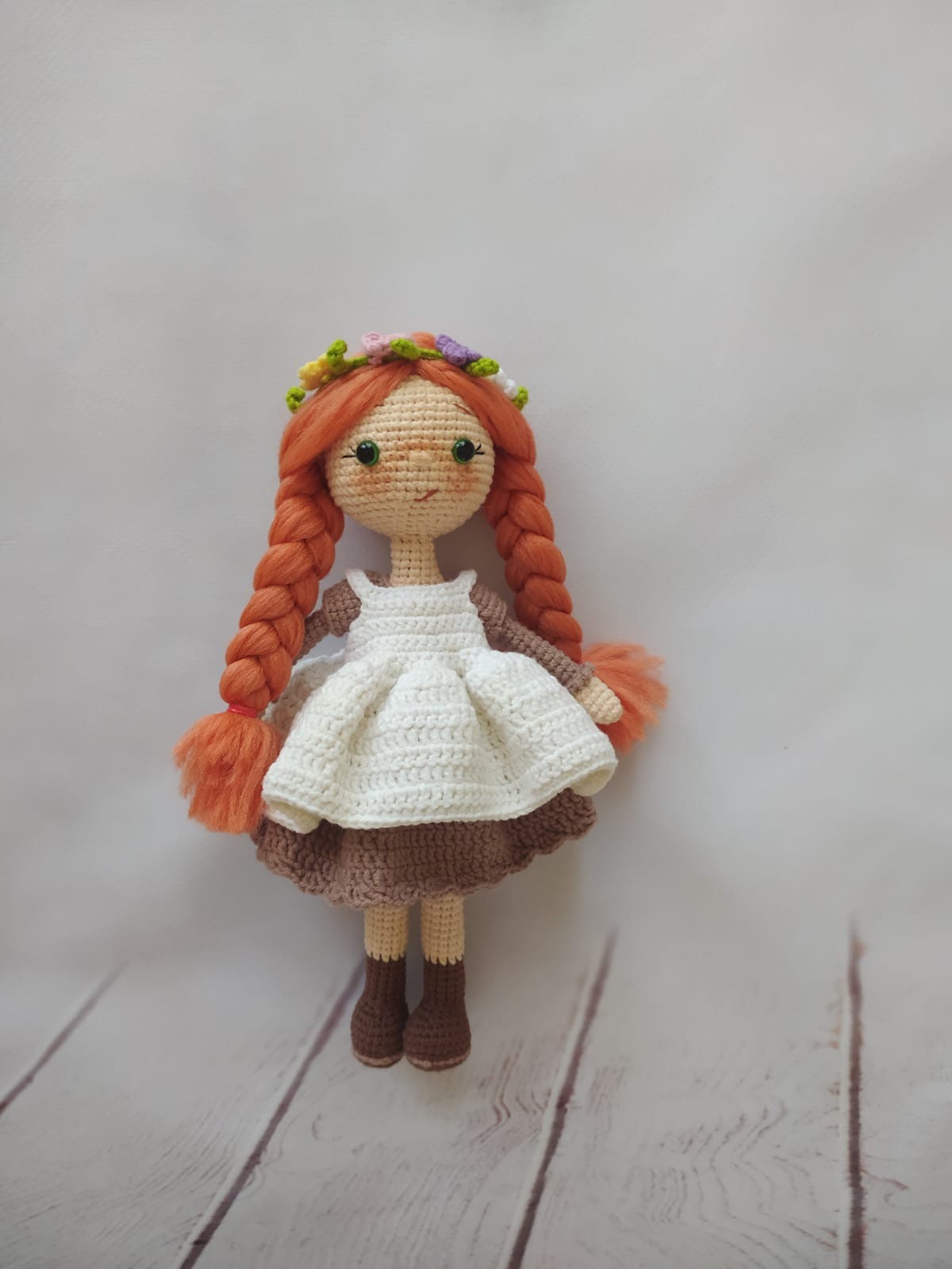 Crocheted Anne of Green Gables Doll with red hair, beige hat, and two dresses. Handmade with care to capture the essence of the beloved literary character. perfect for gifting to fans of the book series or anyone who loves dolls and handmade crafts.