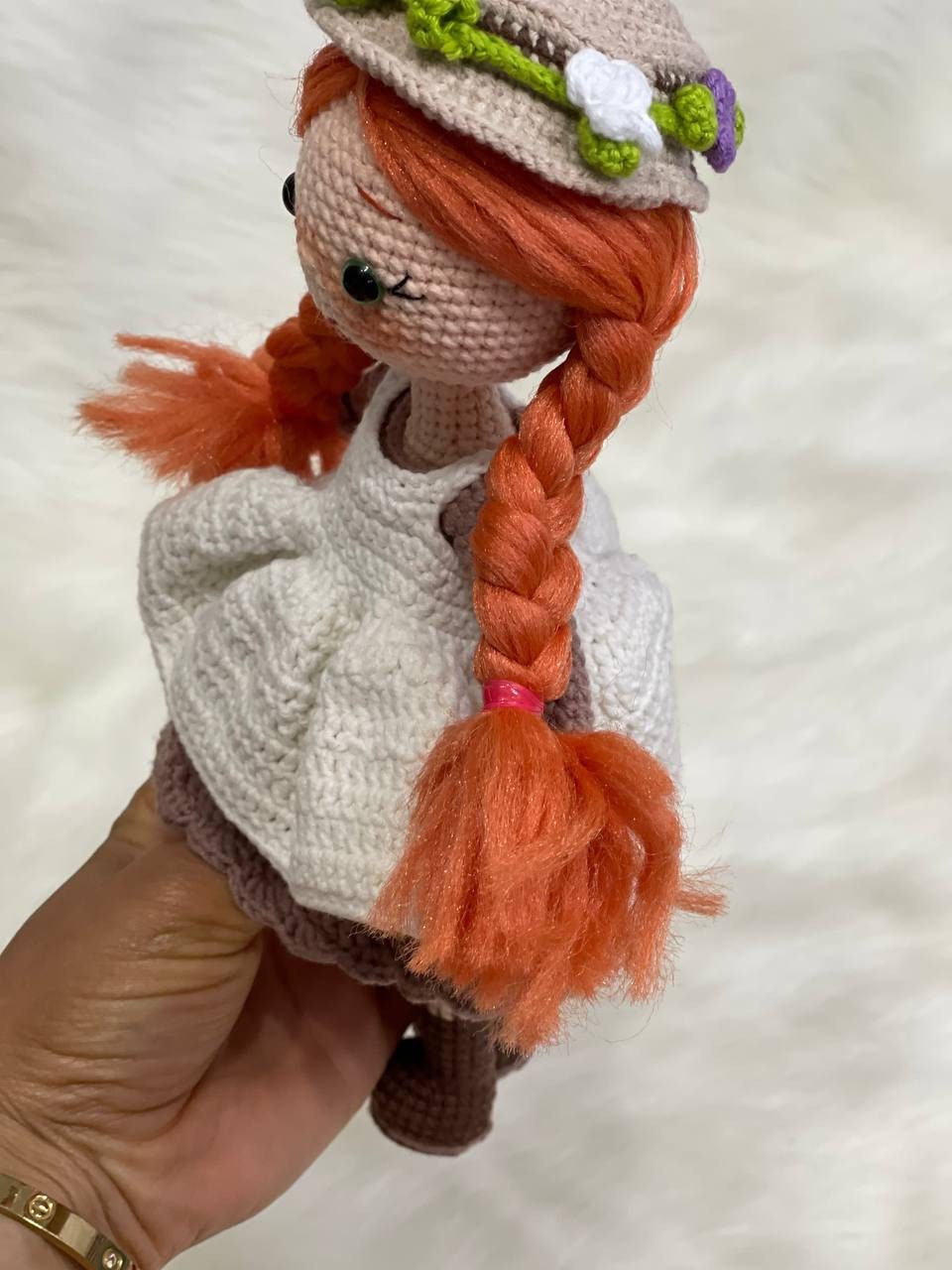 Crocheted Anne of Green Gables Doll with red hair, beige hat, and two dresses. Handmade with care to capture the essence of the beloved literary character. perfect for gifting to fans of the book series or anyone who loves dolls and handmade crafts.