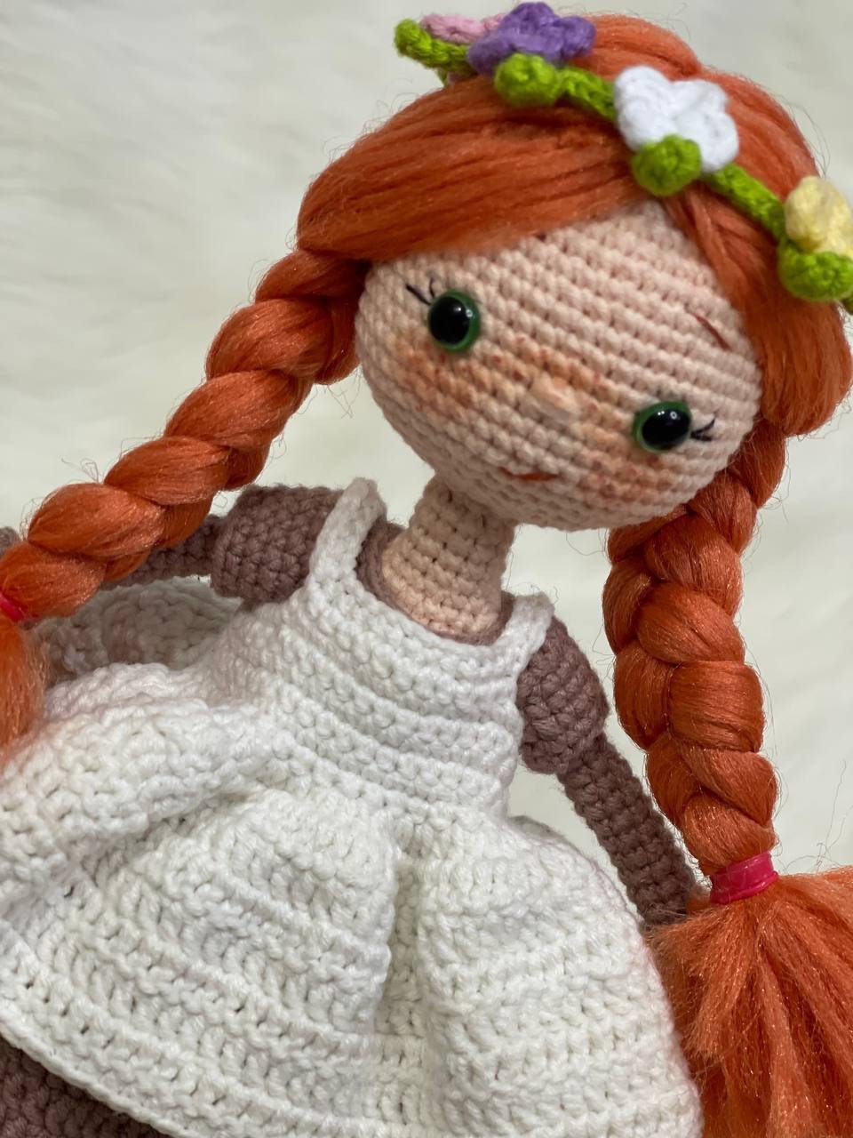 Crocheted Anne of Green Gables Doll with red hair, beige hat, and two dresses. Handmade with care to capture the essence of the beloved literary character. perfect for gifting to fans of the book series or anyone who loves dolls and handmade crafts.