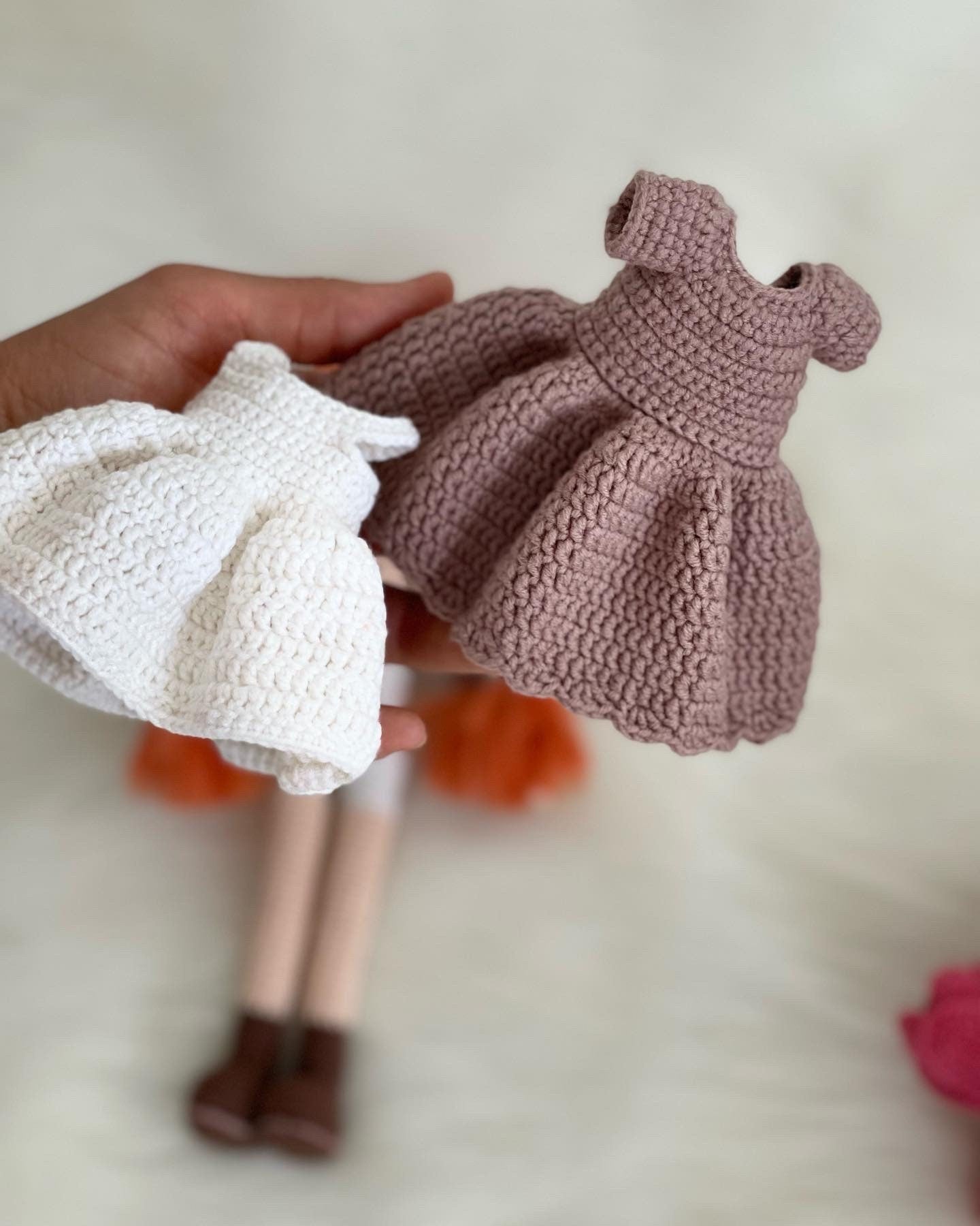 Crocheted Anne of Green Gables Doll with red hair, beige hat, and two dresses. Handmade with care to capture the essence of the beloved literary character. perfect for gifting to fans of the book series or anyone who loves dolls and handmade crafts.