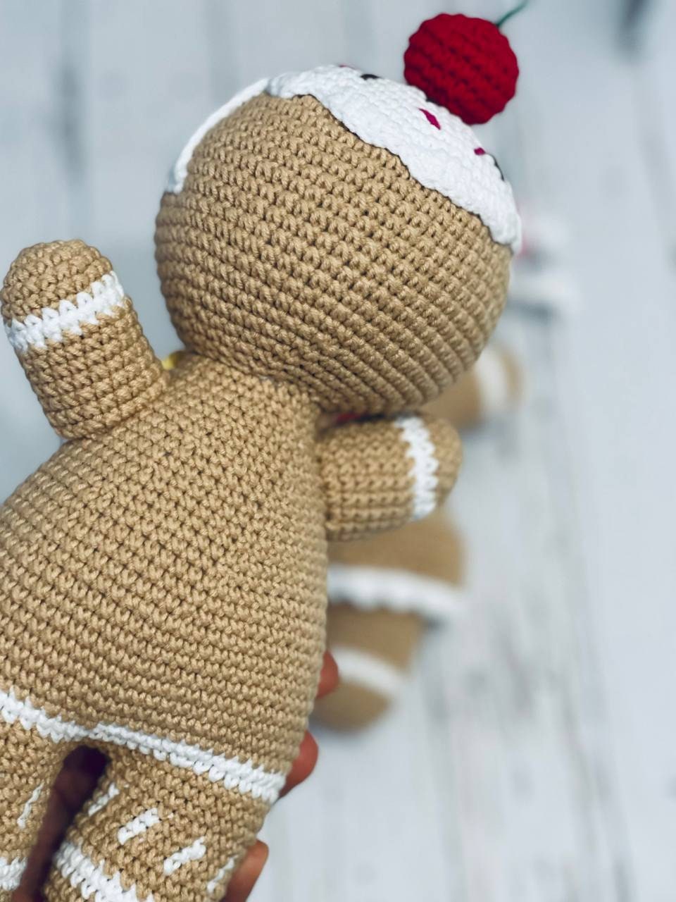 A pair of Crochet Gingerbread toys - Mr and Mrs Gingerbread, with intricate detailing on their icing and fruit decorations. These soft and cuddly gingerbread toys are hand crocheted with chenille yarn and stand approximately 23-25 cm tall.
