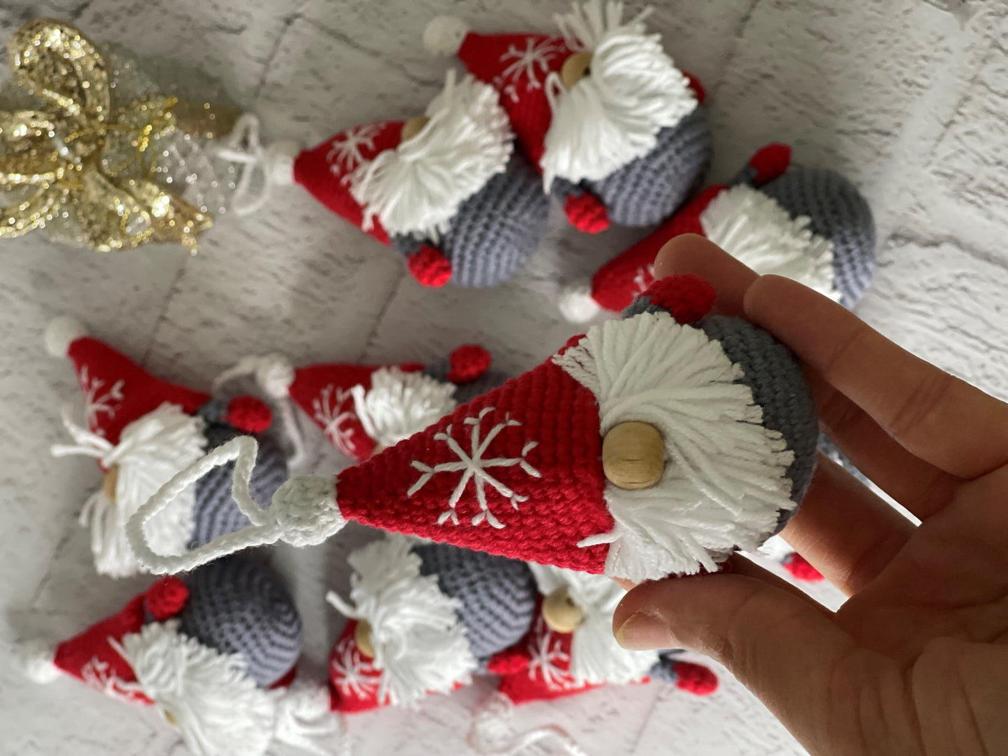 Handmade crochet Christmas decoration of a Scandinavian gnome, also known as a Gonk, with a red and white striped hat and a fluffy white beard. Perfect for adding a cozy and festive touch to your holiday decor. Made with love by a skilled artisan
