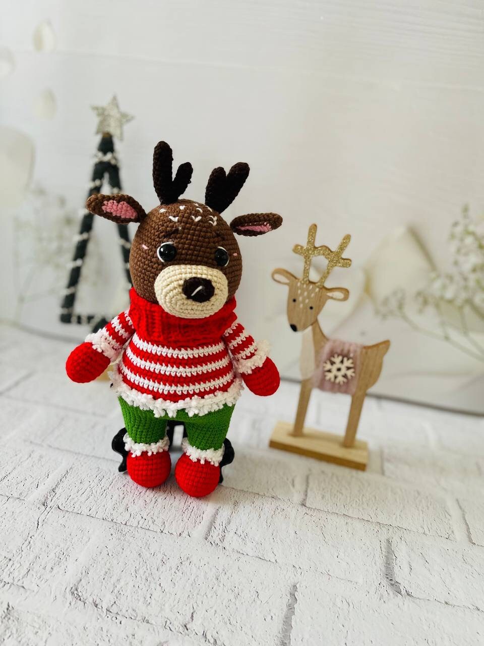 Handmade crochet reindeer toy in brown with a green and red sweater and black antlers. Standing at 25cm tall,amigurumi reindeer is the perfect addition to your holiday decor. Crocheted reindeer plushie with intricate stitching, eco-friendly materials