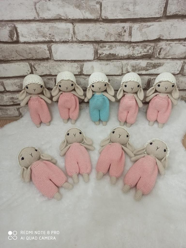 Hand crocheted cute bunny with a hanging pant made of pastel colors. The bunny is made of soft yarn and measures approximately 20cm in height Its hanging pant has beautiful stripes This adorable bunny is a great gift for anyone who loves cute animals