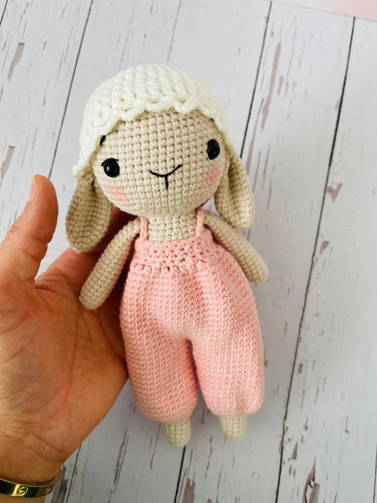 Hand crocheted cute bunny with a hanging pant made of pastel colors. The bunny is made of soft yarn and measures approximately 20cm in height Its hanging pant has beautiful stripes This adorable bunny is a great gift for anyone who loves cute animals