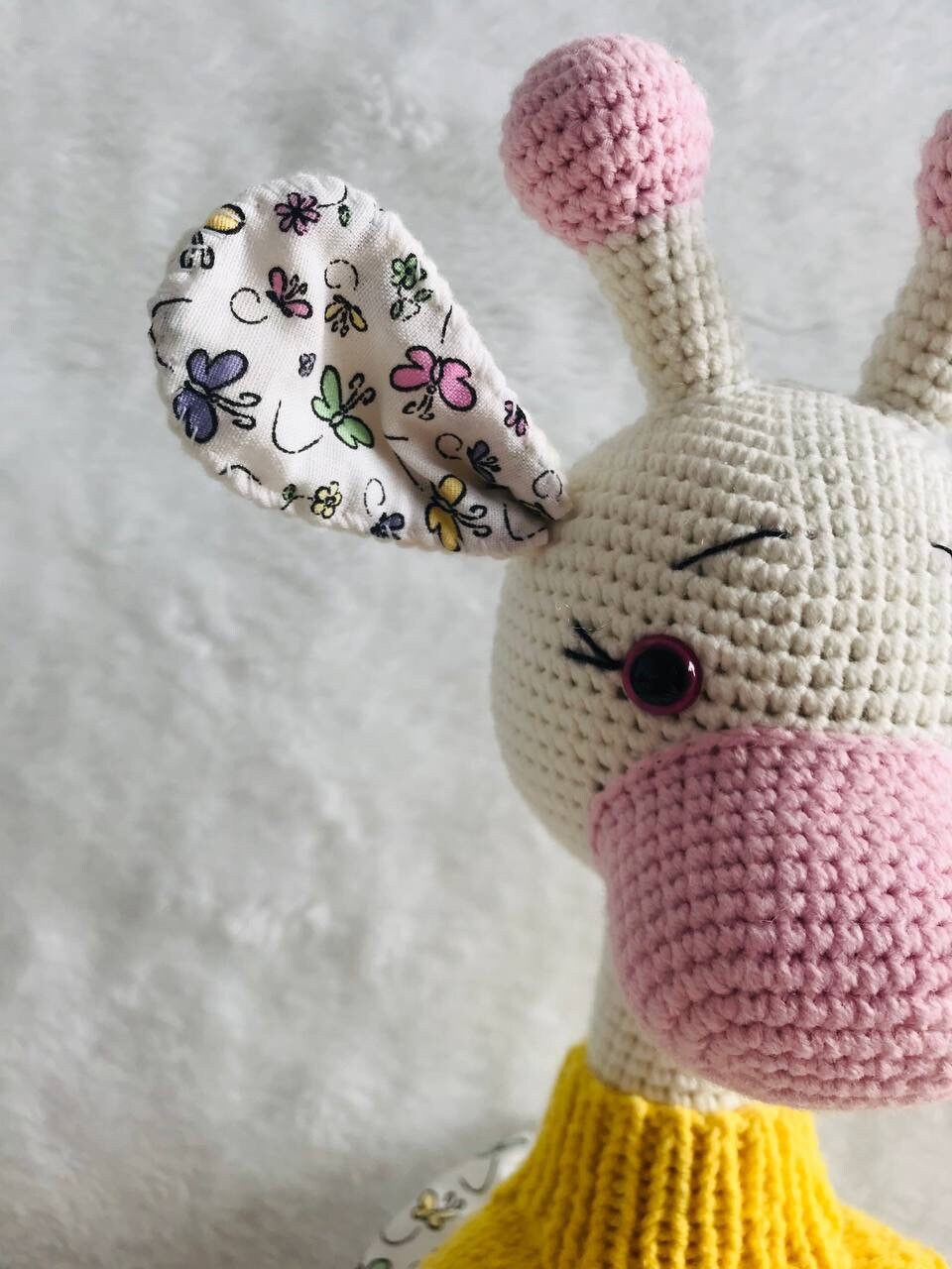 A beautifully crafted crochet giraffe toy, a perfect keepsake for a baby's nursery
