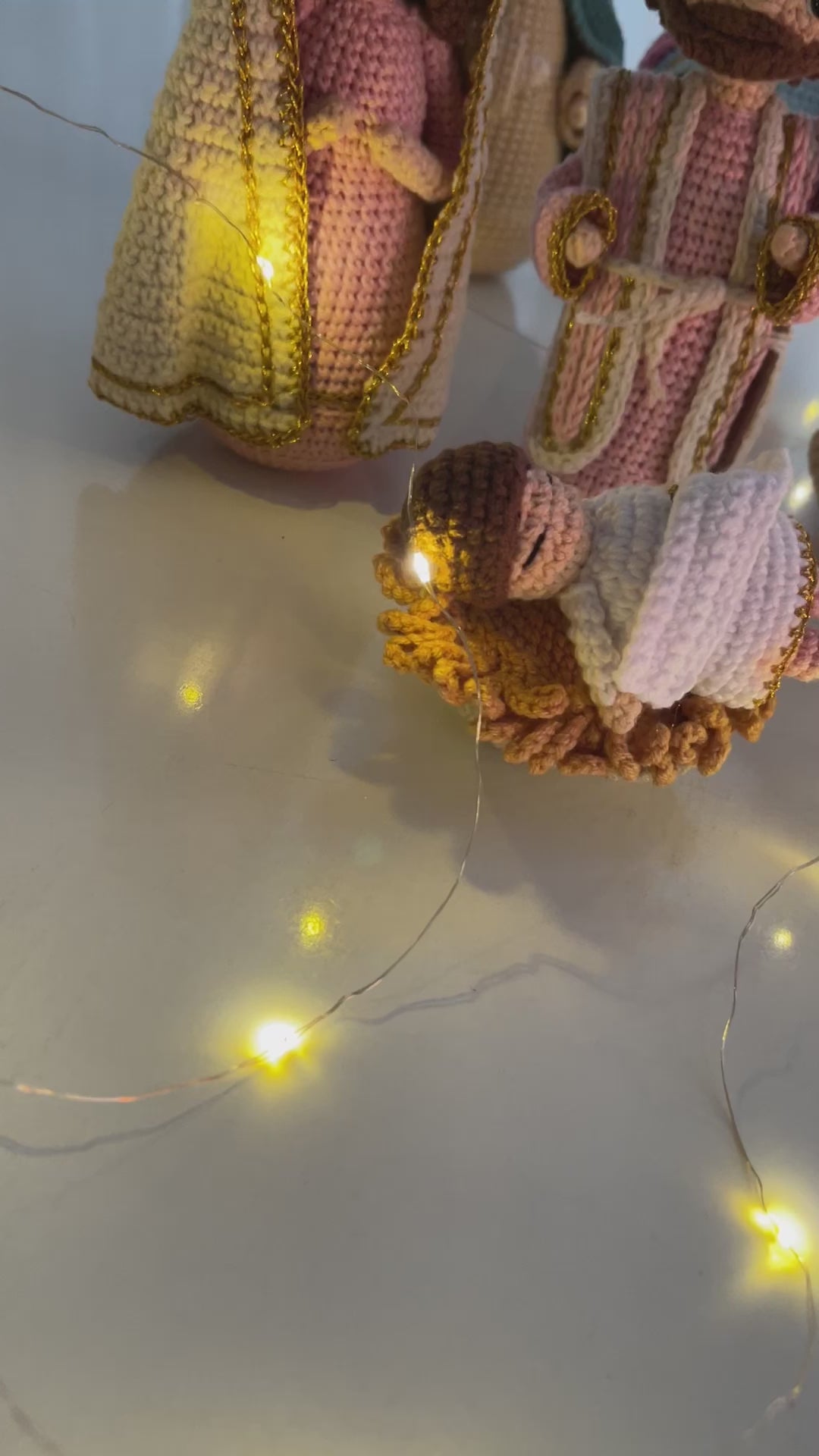 Handmade yarn figures depicting the Nativity scene, including the Holy Family, the Magi with a camel, a shepherd with sheep, and a camel