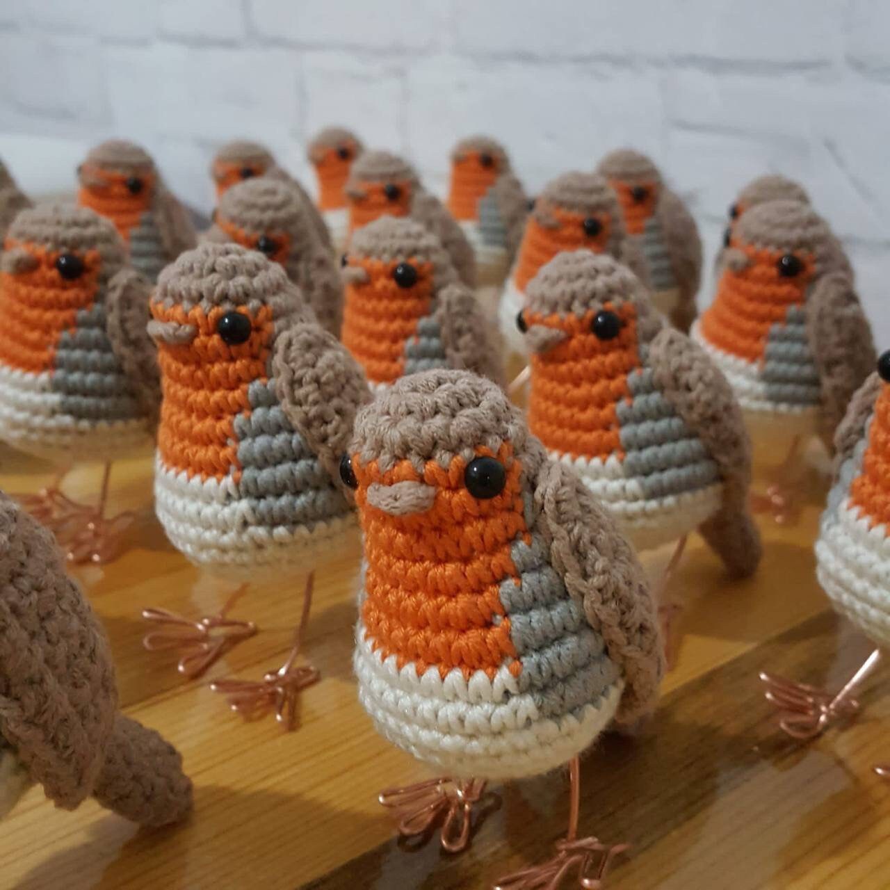 A detailed crochet bird with the characteristic red breast of a robin
