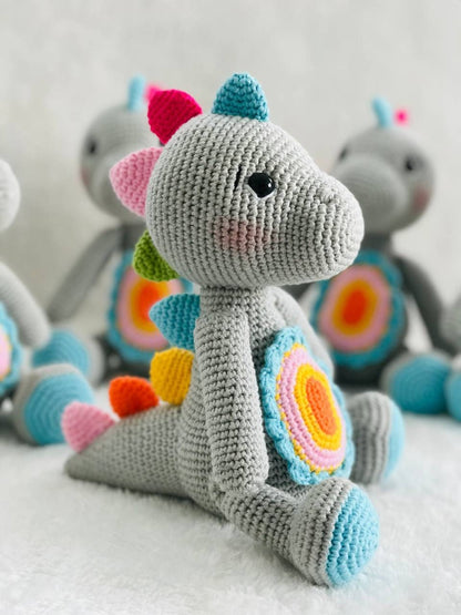 Handmade crochet baby dinosaur toy with soft yarn and embroidered features Cute and cuddly crochet baby dinosaur with embroidered details Small handmade crochet dinosaur toy for babies and toddlers Adorable crochet dinosaur with embroidered eyes