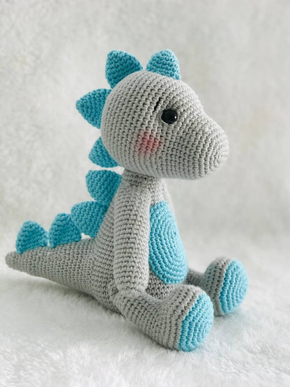 Handmade crochet baby dinosaur toy with soft yarn and embroidered features Cute and cuddly crochet baby dinosaur with embroidered details Small handmade crochet dinosaur toy for babies and toddlers Adorable crochet dinosaur with embroidered eyes