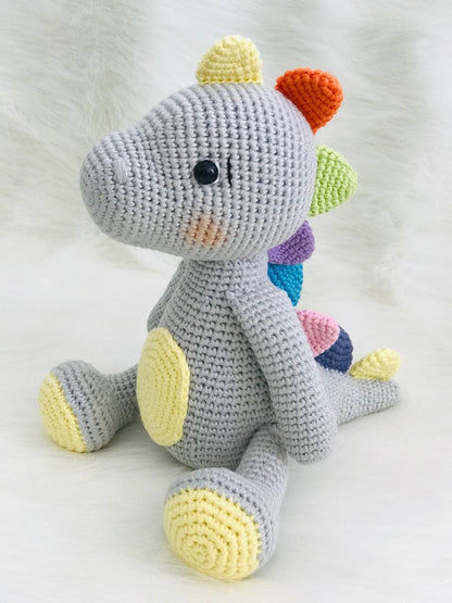 Handmade crochet baby dinosaur toy with soft yarn and embroidered features Cute and cuddly crochet baby dinosaur with embroidered details Small handmade crochet dinosaur toy for babies and toddlers Adorable crochet dinosaur with embroidered eyes