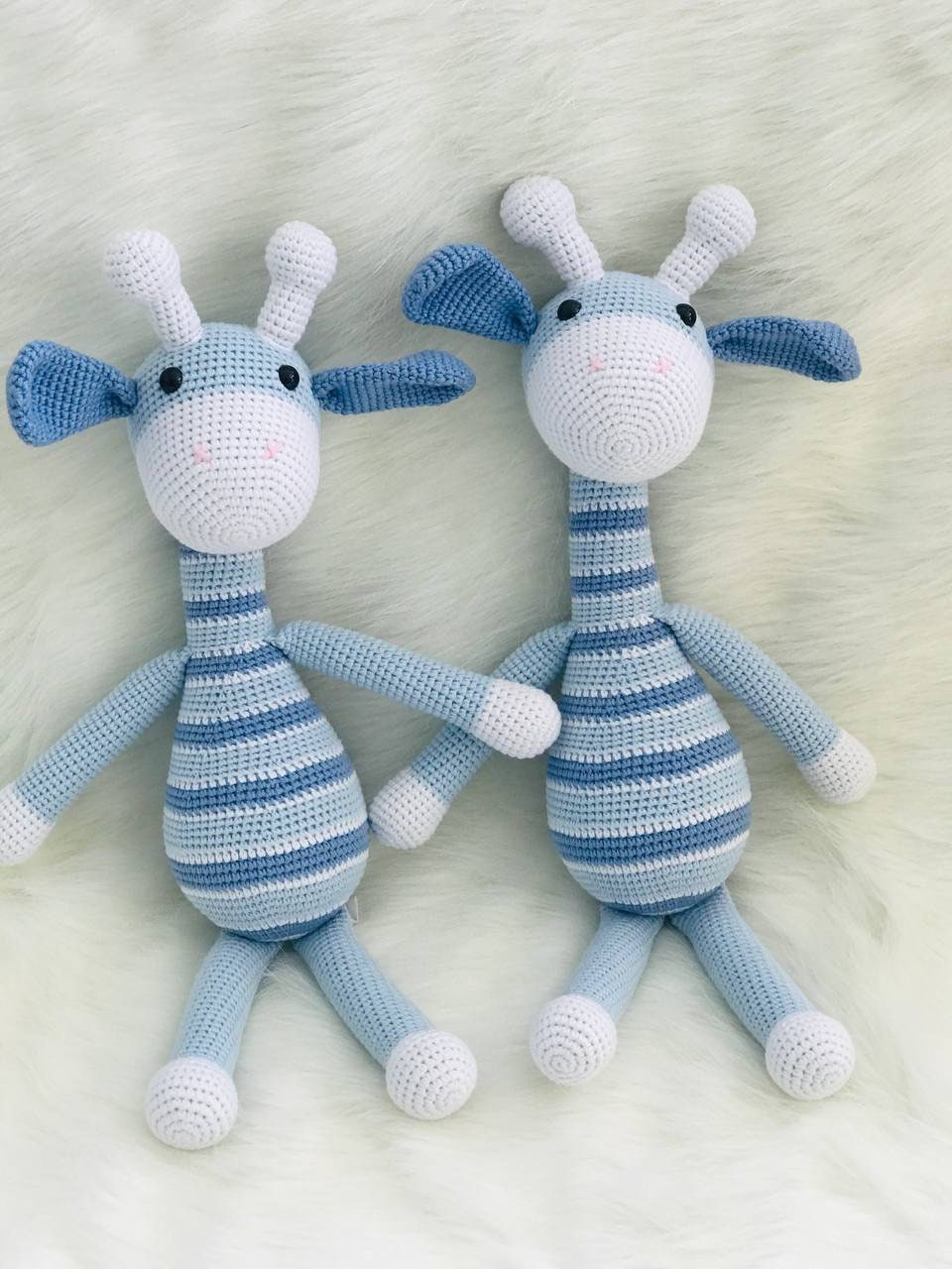 This is an instantly eye-catching a crocheted dark and light blue giraffe with a white horn! The giraffe appears to have been made from soft, colorful yarn that&#39;s been cleverly shaped and manipulated by skilled hands into its gentle curves.