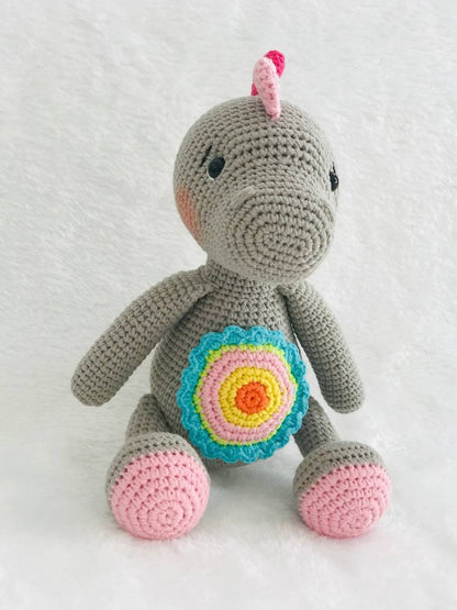 Handmade crochet baby dinosaur toy with soft yarn and embroidered features Cute and cuddly crochet baby dinosaur with embroidered details Small handmade crochet dinosaur toy for babies and toddlers Adorable crochet dinosaur with embroidered eyes