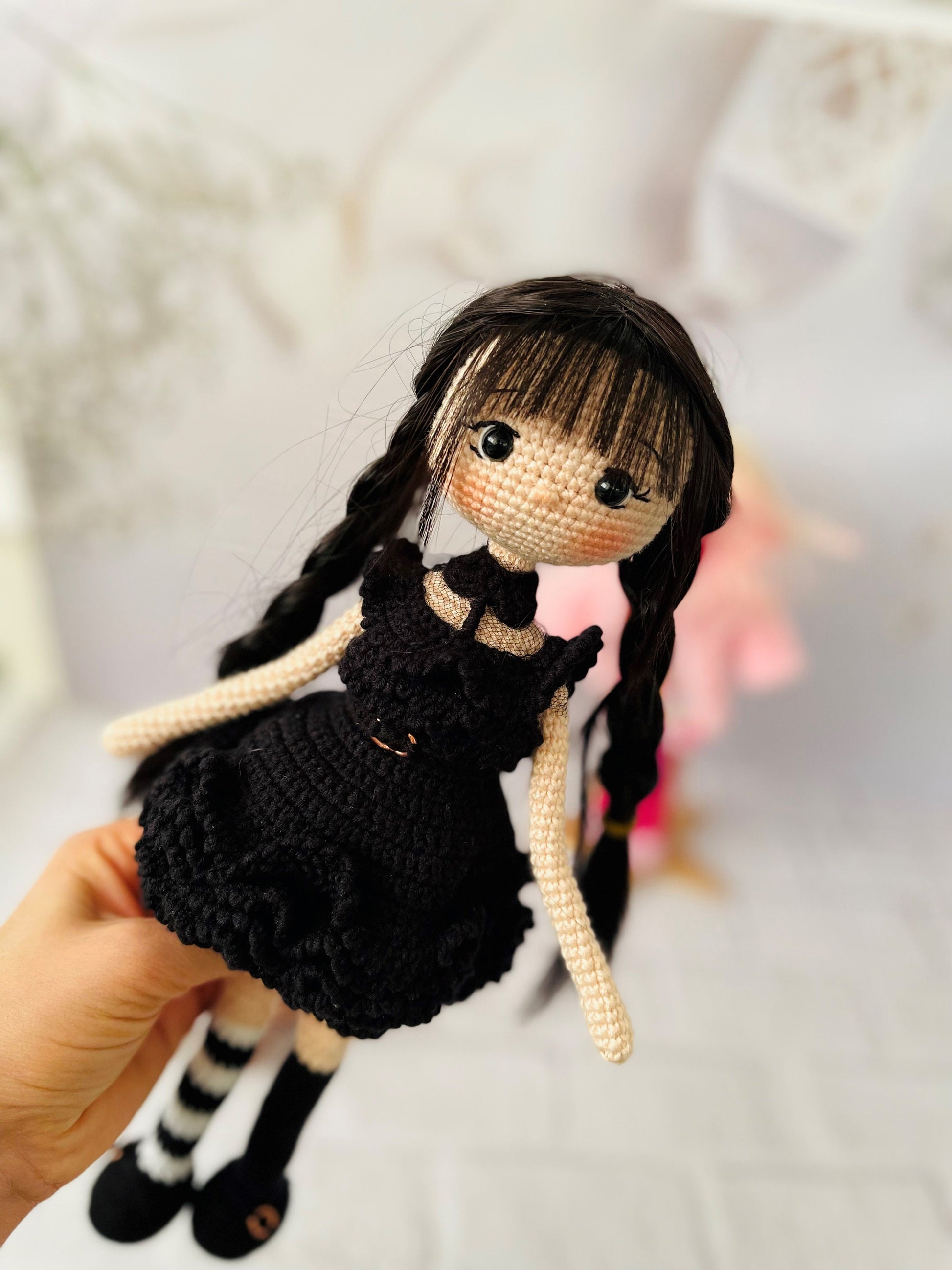 Handmade crochet doll in Wednesday Addams-inspired dress, with long black hair and serious expression. Adorable and unique gift for fans of the classic character. Ideal for imaginative play or as a decorative accent. Made with high-quality materials