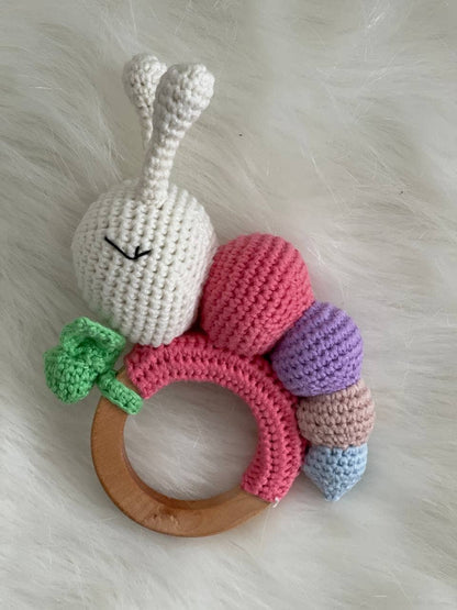 Handmade caterpillar crochet rattle with a wooden ring for babies to grip